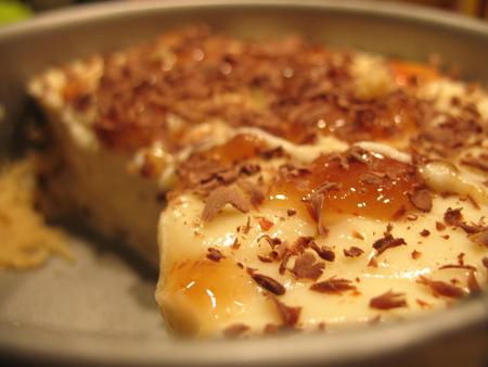 Homemade white-chocolate-ginger-cheesecake with a sauce of caramel and sweet chili, and some chocolate sprinkles.